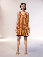 Ame reversible dress by Blissfully Brand in bold orange and yellow abstract pattern. Versatile sleeveless design, black reversed solid, perfect for any occasion